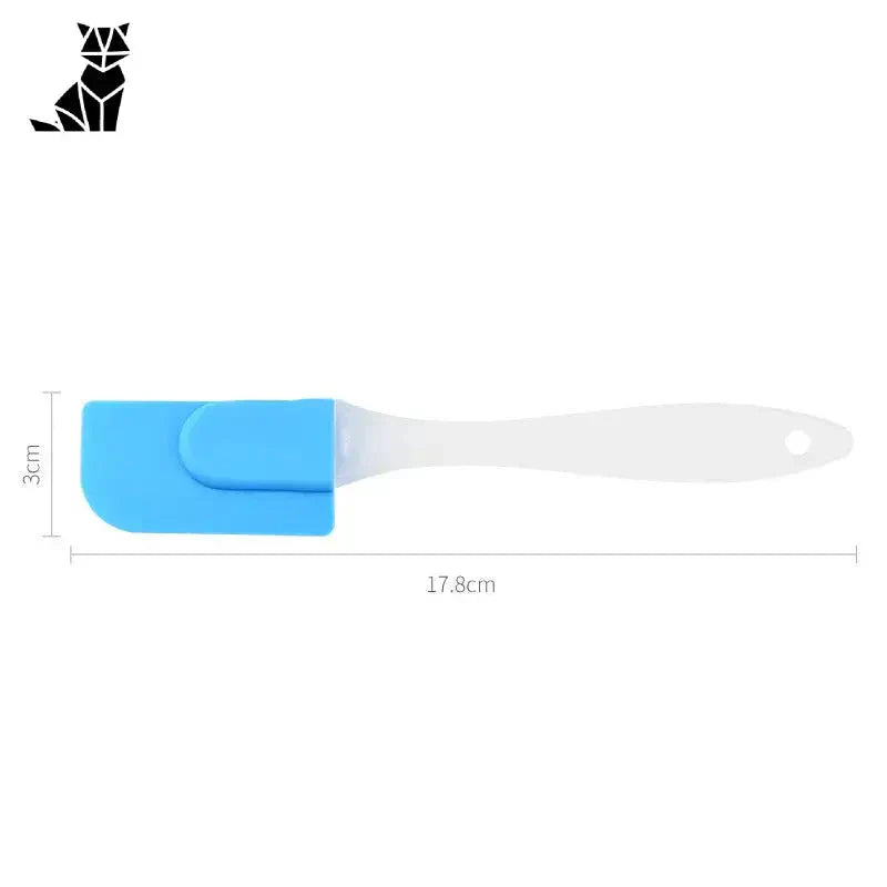 Brosse à dents bleue avec manche blanc sur un tapis à lécher pour chien - Alimentation lente et distraction